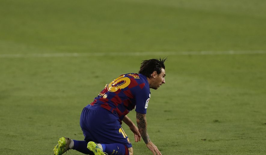 Barcelona's Lionel Messi reacts during the Spanish La Liga soccer match between Sevilla and FC Barcelona at the Ramon Sanchez-Pizjuan stadium in Seville, Spain, Friday, June 19, 2020. (AP Photo/Angel Fernandez)