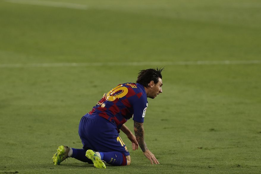 Barcelona's Lionel Messi reacts during the Spanish La Liga soccer match between Sevilla and FC Barcelona at the Ramon Sanchez-Pizjuan stadium in Seville, Spain, Friday, June 19, 2020. (AP Photo/Angel Fernandez)
