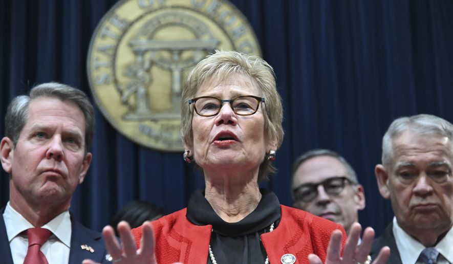 FILE - In this Thursday, March 12, 2020 file photo, Dr. Kathleen Toomey, commissioner of the Georgia Department of Public Health, speaks during a news conference at the Georgia State Capitol in Atlanta to provide an update on the state's efforts regarding COVID-19, after reporting the first death in Georgia related to coronavirus. With the increased public scrutiny, security details have been assigned to Dr. Anthony Fauci, the nation's top infectious disease expert, and top state health officials like Toomey and Ohio's Dr. Amy Acton following protests by armed demonstrators and threats against the two women. (Hyosub Shin/Atlanta Journal-Constitution via AP)