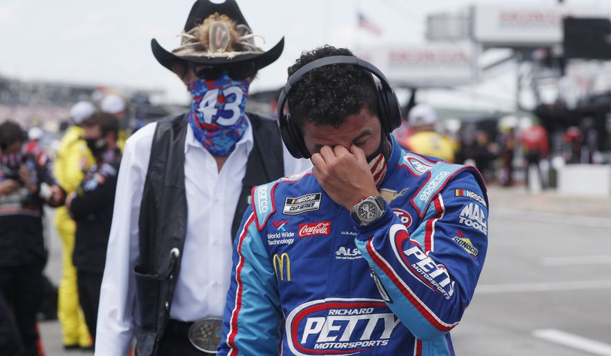 Team owner Richard Petty, left watches as driver Bubba Wallace wipes away tears prior to the start of the NASCAR Cup Series at the Talladega Superspeedway in Talladega, Ala., Monday, June 22, 2020. (AP Photo/John Bazemore)