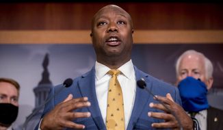 In this June 17, 2020, photo, Sen. Tim Scott, R-S.C., accompanied by Republican senators, speaks at a news conference to announce a Republican police reform bill on Capitol Hill in Washington. Initially reluctant to speak on race, Scott is now among the Republican Party’s most prominent voices teaching his colleagues what it’s like to be a Black man in America. (AP Photo/Andrew Harnik) **FILE**