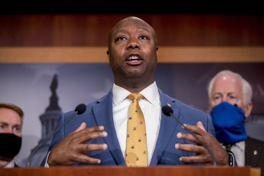 In this June 17, 2020, photo, Sen. Tim Scott, R-S.C., accompanied by Republican senators, speaks at a news conference to announce a Republican police reform bill on Capitol Hill in Washington. Initially reluctant to speak on race, Scott is now among the Republican Party’s most prominent voices teaching his colleagues what it’s like to be a Black man in America. (AP Photo/Andrew Harnik) **FILE**