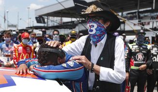 NASCAR driver Bubba Wallace is consoled by team owner Richard Petty, right, prior to the start of the NASCAR Cup Series at the Talladega Superspeedway in Talladega, Ala., Monday, June 22, 2020. In an extraordinary act of solidarity with Wallace, NASCAR&#39;s only Black driver, dozens of drivers pushed his car to the front of the field before Monday&#39;s race. (AP Photo/John Bazemore)