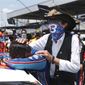 NASCAR driver Bubba Wallace is consoled by team owner Richard Petty, right, prior to the start of the NASCAR Cup Series at the Talladega Superspeedway in Talladega, Ala., Monday, June 22, 2020. In an extraordinary act of solidarity with Wallace, NASCAR&#39;s only Black driver, dozens of drivers pushed his car to the front of the field before Monday&#39;s race. (AP Photo/John Bazemore)
