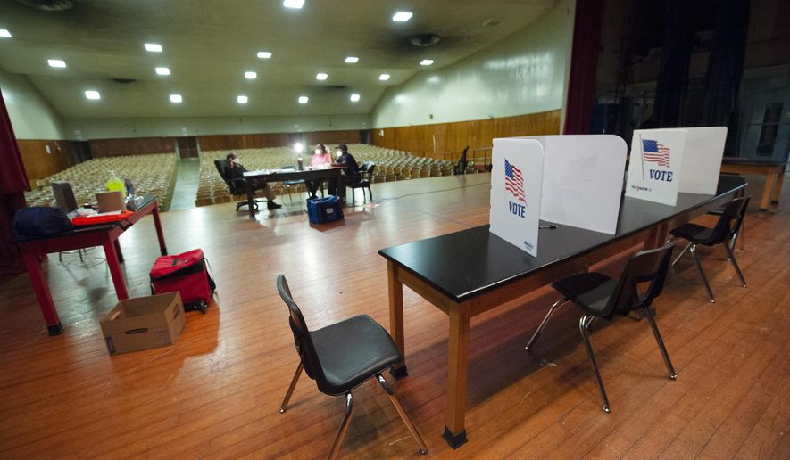 Poll workers try to pass the time during a long morning with no voters up to this point at precinct 38 at Chastain Middle School in Jackson, Miss., Tuesday, June 23, 2020, during the GOP nominee runoff election between Brian Flowers and Thomas Carey for the District 2 Congressional seat. The winner will advance to the November general election to face Democratic U.S. Rep. Bennie Thompson. (Barbara Gauntt/The Clarion-Ledger via AP)