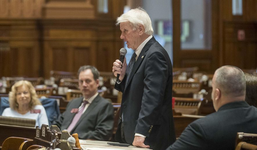 Georgia House Majority leader Rep. Jon Burns, center, R-Newington, tells the speaker of the House that we wishes to adjourn the session in the House Chambers during the 29th day, Friday, March 13, 2020 in Atlanta. There were fewer than 10 members of the Georgia House of Representatives that showed up to the session. Out of caution and in relation to the coronavirus, the Georgia General General Assembly suspended the legislative session until further notice. (Alyssa Pointer/Atlanta Journal-Constitution via AP)