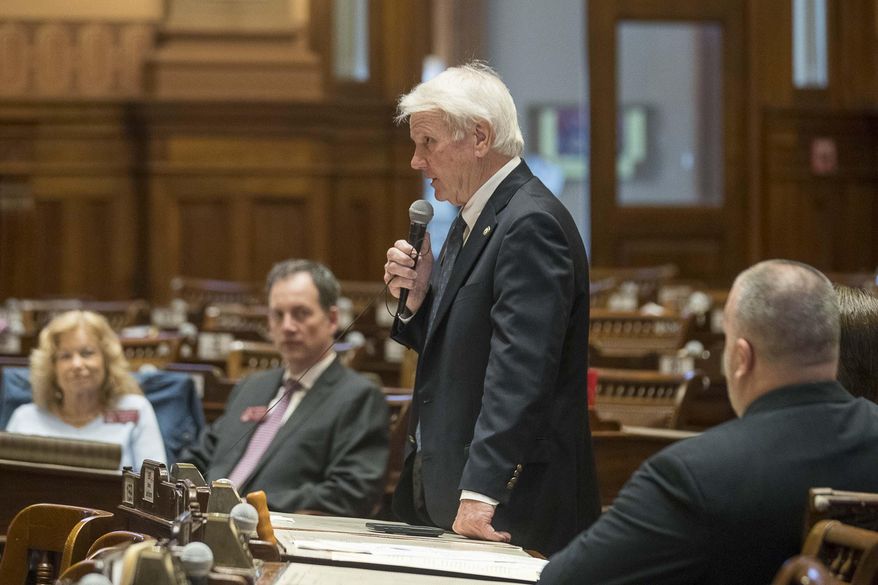 Georgia House Majority leader Rep. Jon Burns, center, R-Newington, tells the speaker of the House that we wishes to adjourn the session in the House Chambers during the 29th day, Friday, March 13, 2020 in Atlanta. There were fewer than 10 members of the Georgia House of Representatives that showed up to the session. Out of caution and in relation to the coronavirus, the Georgia General General Assembly suspended the legislative session until further notice. (Alyssa Pointer/Atlanta Journal-Constitution via AP)