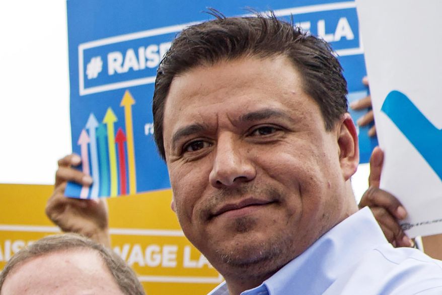 In this June 13, 2015, file photo Los Angeles City Councilman Jose Huizar is seen at the signing of a minimum-wage ordinance at Martin Luther King Jr. Park in Los Angeles. Huizar, who has been under the cloud of a federal corruption investigation, was arrested Tuesday, June 23, 2020, the FBI said. Councilman Huizar was taken into custody without incident at his Boyle Heights home, said FBI spokeswoman Laura Eimiller. The mayor and other city leaders have been calling for Huizar to resign since his former special assistant agreed to plead guilty in a $1 million bribery scheme involving real estate developers. (AP Photo/Ringo H.W. Chiu, File)