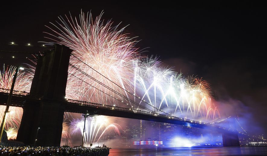 FILE- In this July 4, 2019 file photo, fireworks light up the sky above the Brooklyn Bridge during Macy's Fourth of July fireworks show in New York. This year's July 4th fireworks celebration will go forward in New York City, but with a twist meant to keep spectators from congregating in large numbers during the coronavirus pandemic. (AP Photo/Frank Franklin II, File)