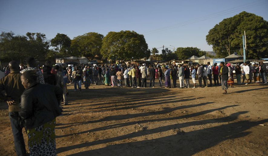 Malawians queue to cast their votes in Blantyre, Malawi Tuesday, June 23 2020. Polls have opened in Malawi and voters began casting their ballots Tuesday in a rerun of the presidential poll after the courts nullified the results of the election held more than a year ago. (AP Photo/Thoko Chikondi)
