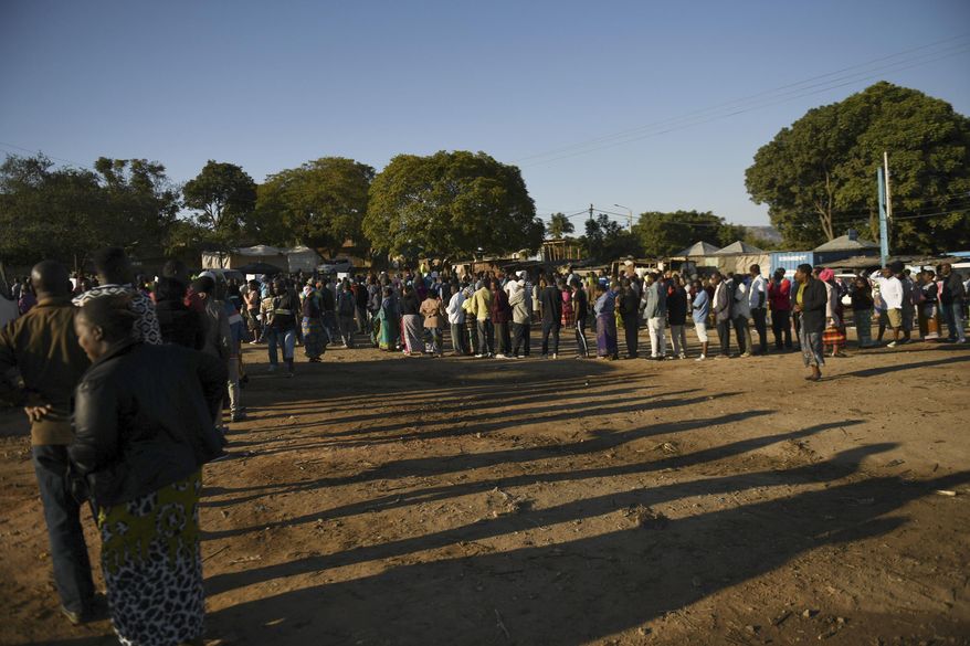 Malawians queue to cast their votes in Blantyre, Malawi Tuesday, June 23 2020. Polls have opened in Malawi and voters began casting their ballots Tuesday in a rerun of the presidential poll after the courts nullified the results of the election held more than a year ago. (AP Photo/Thoko Chikondi)