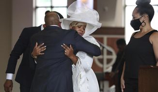 The Rev. Raphael G. Warnock, senior pastor of Ebenezer Baptist Church, comforts Tomika Miller, the wife of Rayshard Brooks during his public viewing at Ebenezer Baptist Church on Monday, Jun 22, 2020, in Atlanta. Brooks, 27, died June 12 after being shot by an officer in a Wendy&#39;s parking lot. Brooks&#39; death sparked protests in Atlanta and around the country. A private funeral for Brooks will be held Tuesday at the church. (Curtis Compton/Atlanta Journal-Constitution via AP, Pool)