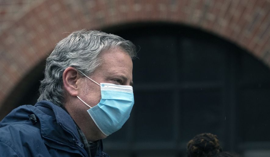 In this April 24, 2020, file photo, New York City Mayor Bill de Blasio wears a mask while honoring health care workers at Brooklyn's Kings County Hospital Center in New York. (AP Photo/Mark Lennihan, File)