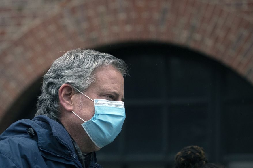 In this April 24, 2020, file photo, New York City Mayor Bill de Blasio wears a mask while honoring health care workers at Brooklyn's Kings County Hospital Center in New York. (AP Photo/Mark Lennihan, File)
