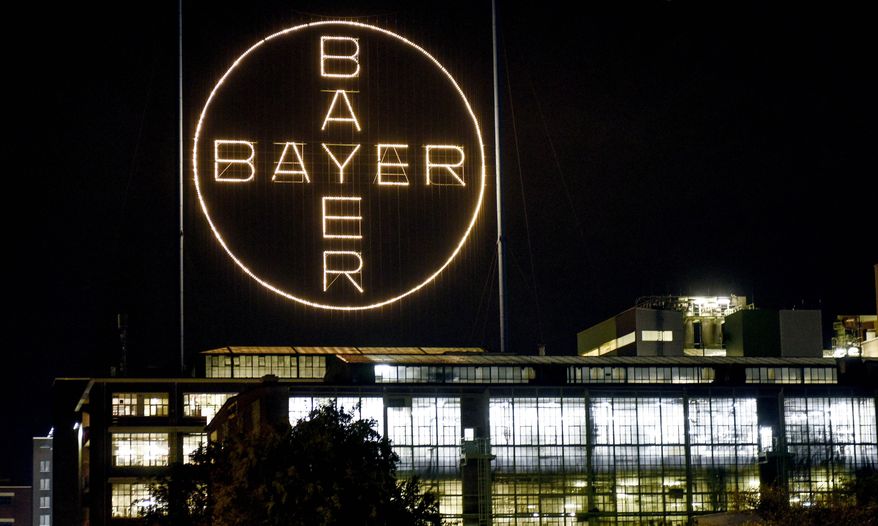 FILE - In this Aug. 9, 2019, file photo, the Bayer logo shines at night at the main chemical plant of German Bayer AG in Leverkusen, Germany. The German pharmaceutical company announced Wednesday, June 24, 2020, it’s paying up to $10.9 billion to settle a lawsuit over subsidiary Monsanto’s weedkiller Roundup, which has faced numerous lawsuits over claims it causes cancer.  (AP Photo/Martin Meissner, File)