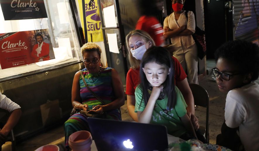 Supporters of and volunteers for Rep. Yvette Clarke, D-N.Y., follow primary returns Tuesday, June 23, 2020, from Clarke's campaign headquarters in the Brooklyn borough of New York. (AP Photo/Kathy Willens)
