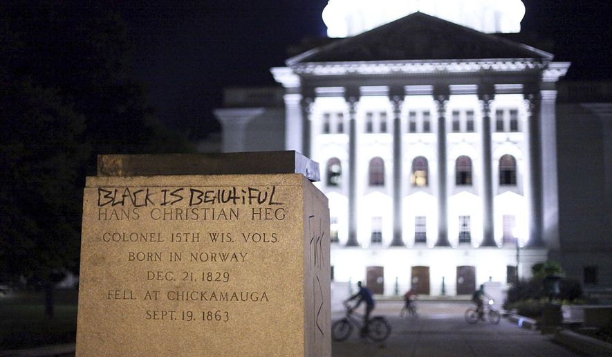 The base of a statue of Col. Hans Christian Heg, a Union Civil War colonel who fought for the end of slavery, remains after it was torn down by protesters during demonstrations in Madison, Wis. Tuesday, June 23, 2020. Crowds outside the Wisconsin State Capitol tore down two statues and attacked a state senator amid protests following the arrest of a Black man who shouted at restaurant customers through a megaphone while carrying a baseball bat. (Emily Hamer/Wisconsin State Journal via AP)