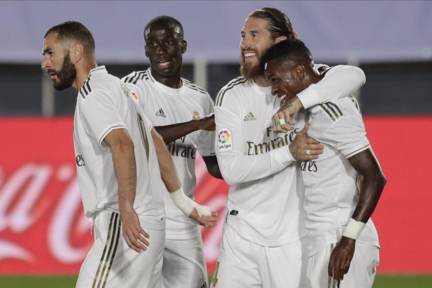 Real Madrid's Vinicius Junior, right, celebrates after scoring the opening goal with teammates during the Spanish La Liga soccer match between Real Madrid and Mallorca at Alfredo di Stefano stadium in Madrid, Spain, Wednesday, June 24, 2020. (AP Photo/Bernat Armangue)