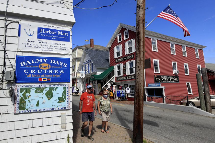 FILE-In this Tuesday, June 9, 2020 file photo, visitors walk through the shopping district in Boothbay Harbor, Maine. State public health officials said Wednesday, June 24, 2020, the state has surpassed 3,000 cases of the coronavirus, though the state is still well behind most of the Northeast. (AP Photo/Robert F. Bukaty, files)