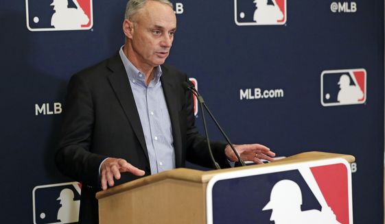 FILE - In this Feb. 6, 2020, file photo, Baseball Commissioner Rob Manfred answers questions at a press conference during baseball owners meetings in Orlando, Fla. Manfred tells The Associated Press that the commissioner&#39;s office, teams and the players&#39; association &amp;quot;owe it to our fans to be better than we&#39;ve been the last three months.&amp;quot; (AP Photo/John Raoux, File)