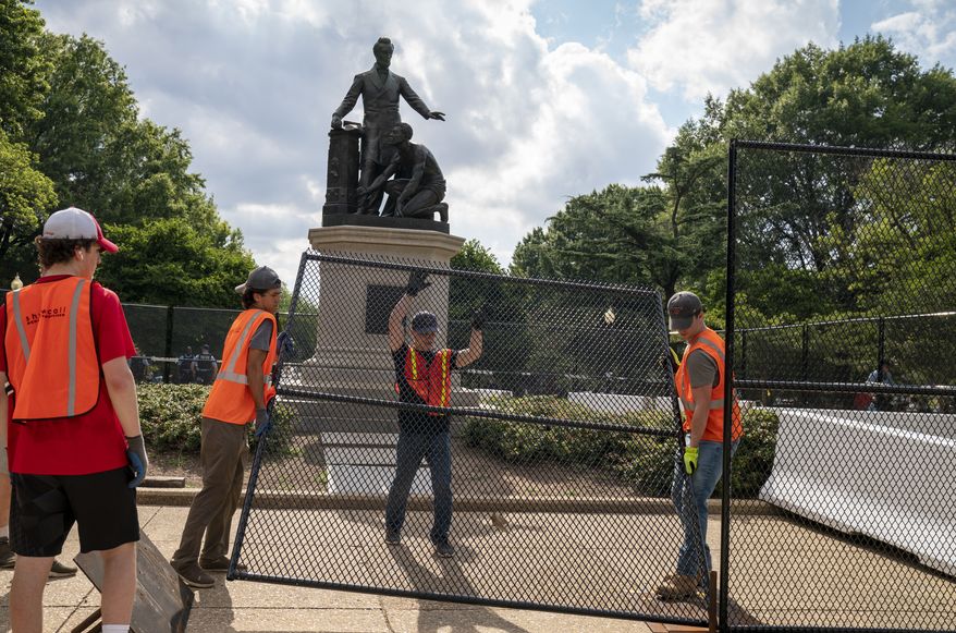 Barriers are erected around the Emancipation Memorial in Washington, which depicts a freed slave kneeling at the feet of President Abraham Lincoln, Thursday, June 25, 2020. Calls are intensifying for the removal of the statue as the nation confronts racial injustice. (AP Photo/J. Scott Applewhite)