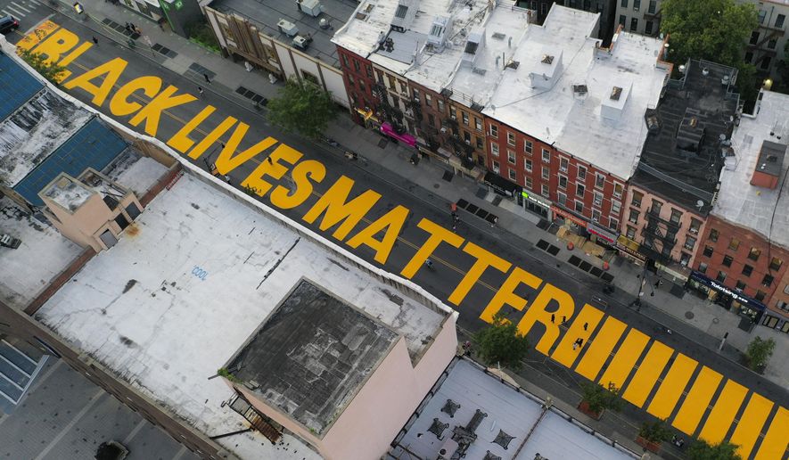 In this June 15, 2020, file photo, a sign reading &amp;quot;Black Lives Matter,&amp;quot; is painted in orange on Fulton Street in the Brooklyn borough of New York. On Thursday, June 25, 2020, President Donald Trump used Twitter to voice his displeasure with New York City Mayor Bill de Blasio&#39;s plan to paint &amp;quot;Black Lives Matter&amp;quot; in front of Trump&#39;s namesake Manhattan tower. (AP Photo/John Minchillo, File)