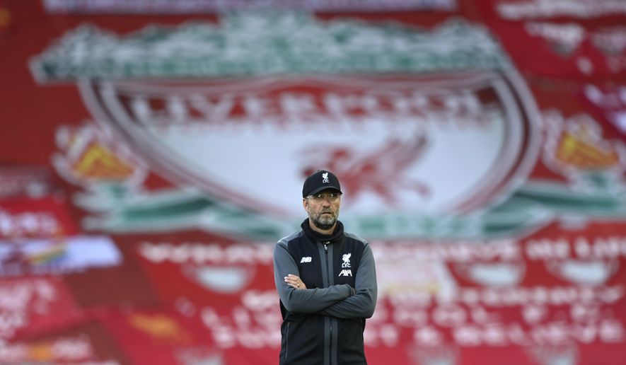 Liverpool's manager Jurgen Klopp stands on the pitch before the English Premier League soccer match between Liverpool and Crystal Palace at Anfield Stadium in Liverpool, England, Wednesday, June 24, 2020. (Shaun Botterill/Pool via AP)