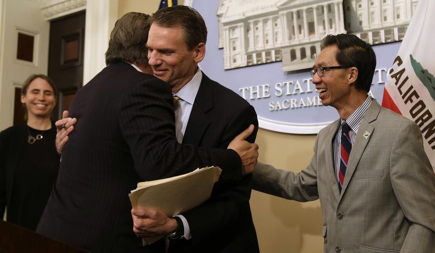 FILE - In this June 28, 2018, file photo, State Sen. Bob Hertzberg, D-Van Nuys, left, and Assemblyman Ed Chau, D-Arcadia, right, celebrate with Alastair Mactaggart, center, after the Legislature approved their data privacy bill in Sacramento, Calif. California voters will decide a ballot measure this November that would give them more power over how companies use their data, an extension of a landmark privacy law passed in 2018. Secretary of State Alex Padilla announced Wednesday, June 25, 2020, a measure to amend the law will be on the Nov. 3 general election ballot. (AP Photo/Rich Pedroncelli, File)