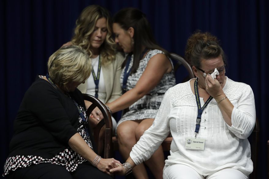 FILE - In this Aug. 14, 2018, file photo victims of clergy sexual abuse, or their family members, react as Pennsylvania Attorney General Josh Shapiro speaks during a news conference at the State Capitol in Harrisburg, Pa. U.S. Roman Catholic bishops said Thursday, June 25, 2020 that the church tallied 4,434 sex abuse allegations against clergy in the 2018-19 audit year, triple the number seen the previous year, with much of the increase stemming from a wave of lawsuits and claims by survivors of decades-old molestation. (AP Photo/Matt Rourke, File)