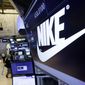 In this March 22, 2017, photo, the Nike logo appears above the post where it trades on the floor of the New York Stock Exchange. (AP Photo/Richard Drew) **FILE**