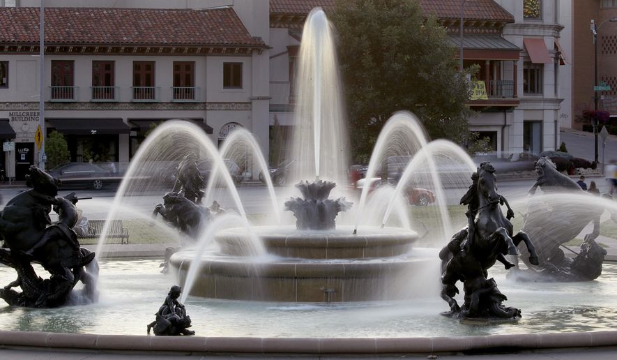 In this photo taken Tuesday, June 23, 2020, the J.C. Nichols fountain is seen in Kansas City, Mo. The city's board of parks and recreation is considering a proposal to remove the J.C. Nichols name from the fountain and a nearby street as they address racial concerns about the influential local developer. Nichols developed some of the area's most desirable neighborhoods as well as the city's County Club Plaza shopping district in the early 1900's but excluded Blacks, Jews and other minorities using deed restrictions on his properties. (AP Photo/Charlie Riedel)
