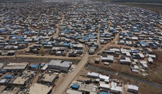 FILE - This April 19, 2020 file photo shows a large refugee camp on the Syrian side of the border with Turkey, near the town of Atma, in Idlib province, Syria. The head of the U.N. food agency warned of starvation and another wave of mass migration from Syria to Europe unless donors countries step up financial assistance to the war-ravaged country. (AP Photo/Ghaith Alsayed, File)