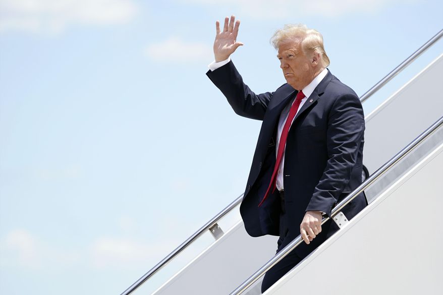 President Donald Trump waves as he arrives on Air Force One at Austin Straubel International Airport in Green Bay, Wis., Thursday, June 25, 2020. (AP Photo/Evan Vucci)