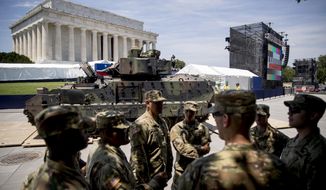 FILE - In this July 3, 2019, file photo one of two Bradley Fighting Vehicles driven into place in front of the Lincoln Memorial for President Donald Trump&#39;s &#39;Salute to America&#39; event honoring service branches on Independence Day in Washington. Government watchdogs say President Trump’s 2019 Fourth of July gala in the nation’s capital cost taxpayers more than $13 million, twice as much as previous celebrations. (AP Photo/Andrew Harnik, File)