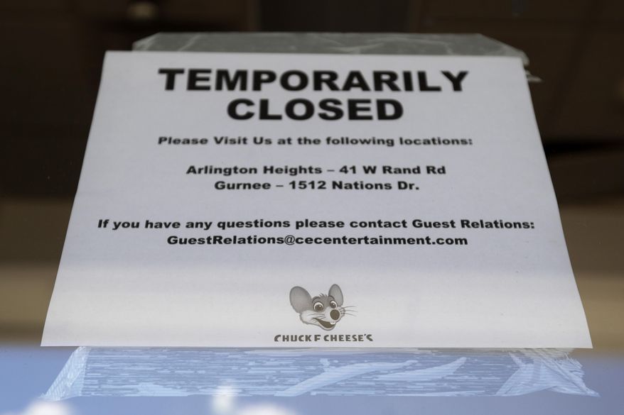 A temporarily closed sign at Chuck E. Cheese store in Vernon Hills, Ill., Thursday, June 25, 2020. Chuck E. Cheese's parent company, CEC Entertainment, filed for bankruptcy Thursday, blaming the financial strain caused by COVID-19 and the prolonged closures of its entertainment centers from stay-at-home orders issued across the United States. (AP Photo/Nam Y. Huh)