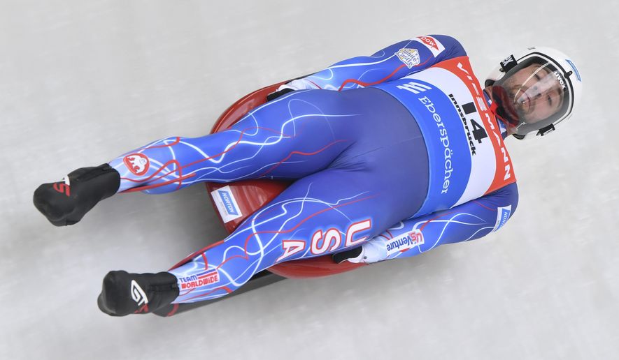 FILE - In this Nov. 24, 2019, file photo, United States's Chris Mazdzer speeds down the course during his first run at the men's luge World Cup race in Igls, Austria. The International Luge Federation is still planning for a full 10-race international season this fall and winter, though has yet to say what protocols will be added to deal with the coronavirus. “I really think it’s going to come down to just creating a safe environment, having people be comfortable and taking the right safety precautions,” said Olympic silver medalist Chris Mazdzer, the longtime USA Luge slider and the athletes’ representative on the FIL Executive Board. (AP Photo/Kerstin Joensson, File)