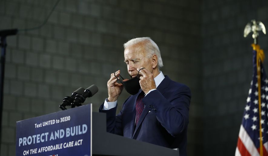 Democratic presidential candidate, former Vice President Joe Biden adjusts his mask after speaking at an event, Thursday, June 25, 2020, in Lancaster, Pa. (AP Photo/Matt Slocum)