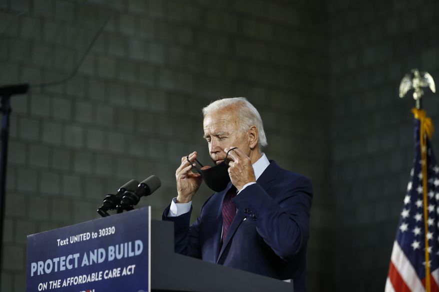 Democratic presidential candidate, former Vice President Joe Biden adjusts his mask after speaking at an event, Thursday, June 25, 2020, in Lancaster, Pa. (AP Photo/Matt Slocum)
