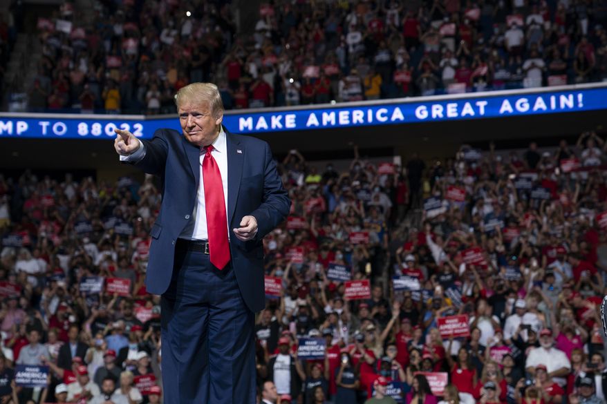In this June 20, 2020, photo, President Donald Trump arrives on stage to speak at a campaign rally at the BOK Center in Tulsa, Okla. President Donald Trump is sharpening his focus on his ardent base of supporters as polls show a diminished standing for the president in battleground states that will decide the 2020 election (AP Photo/Evan Vucci) ** FILE **