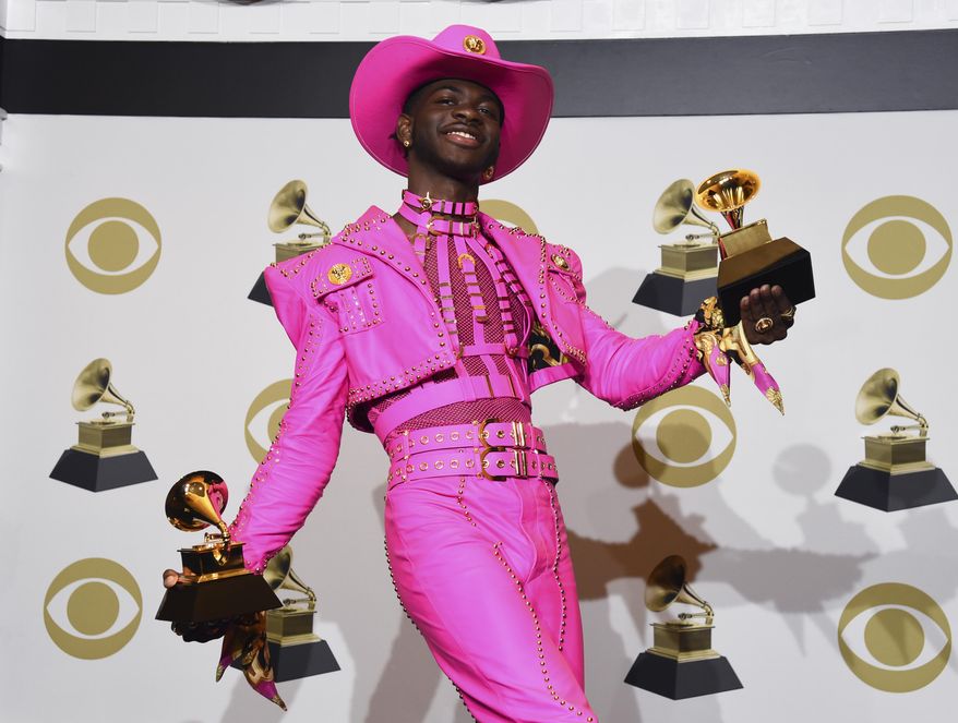 In this Jan. 26, 2020, photo, Lil Nas X poses in the press room with the awards for best music video and best pop duo/group performance for &amp;quot;Old Town Road,&amp;quot; at the 62nd annual Grammy Awards in Los Angeles. (AP Photo/Chris Pizzello) **FILE**