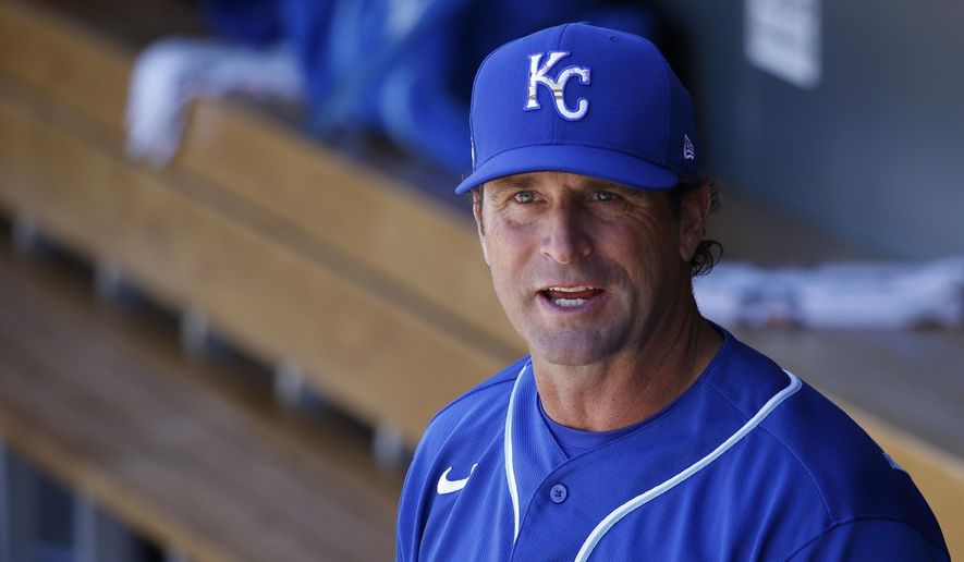 FILE - In this March 9, 2020, file photo, Kansas City Royals manager Mike Matheny pauses in the dugout prior to a spring training baseball game against the Arizona Diamondbacks in Scottsdale, Ariz. Forget about those halcyon first few days of spring training, when arranging for the right tee time on the right golf course is often more challenging than the work on the field. When major leaguers report next week for spring training 2.0 — or perhaps more accurately, baseball's first summer camp — time will be one precious commodity with about three weeks before opening day. “We're going to have some live batting practices the first day they show up. Day 1 and Day 2. ... Multiple ups for the starters," Matheny said Friday, June 26, 2020, on a video conference call. “These guys are prepared for that. They've been hungry for it.” (AP Photo/Ross D. Franklin, File)