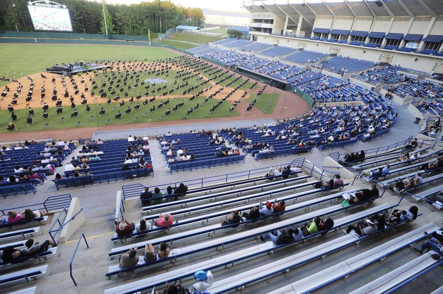 Seniors at Spain Park High School sit on a baseball field during a socially distanced graduation ceremony in Hoover, Ala., Wednesday, May 20, 2020. Health officials say usual graduation ceremonies could endanger the public health by promoting the spread of disease. But school officials say they're using social distancing guidelines and abiding by state health rules. (AP Photo/Jay Reeves)