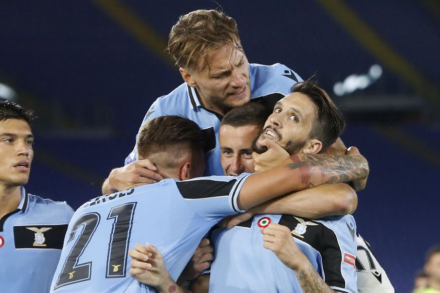 Lazio's Luis Alberto, right, celebrates with his teammates Sergej Milinkovic-Savic,Adam Marusic and Ciro Immobile, on top, after scoring his side's second goal during a Serie A soccer match between Lazio and Fiorentina at Rome's Olympic stadium, Saturday, June 27, 2020. (AP Photo/Riccardo de Luca)