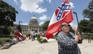 &quot;I love this flag,&quot; states David Flynt of Hattiesburg, while standing outside the state Capitol with other current Mississippi flag supporters in Jackson, Miss., Sunday, June 28, 2020. Lawmakers in both chambers are expected to debate state flag change legislation today. Mississippi Governor Tate Reeves has already said he would sign whatever flag bill the Legislature decides on. (AP Photo/Rogelio V. Solis)