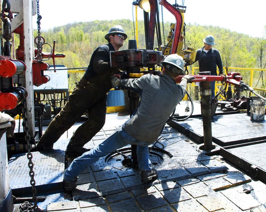 FILE - In this April 23, 2010, file photo, workers move a section of well casing into place at a Chesapeake Energy natural gas well site near Burlington, Pa., in Bradford County. Chesapeake Energy, a shale drilling pioneer that helped to turn the United States into a global energy powerhouse, has filed for bankruptcy protection. The Oklahoma City-based company said Sunday, June 28, 2020, that it was a necessary decision given its debt. Its debt load is currently nearing $9 billion. (AP Photo/Ralph Wilson, File)