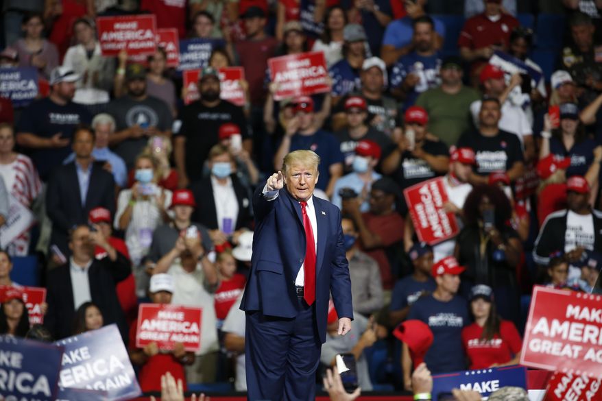 FILE - In this June 20, 2020, file photo, President Donald Trump speaks during a campaign rally at the BOK Center in Tulsa, Okla. The coronavirus pandemic isn&#39;t going away anytime soon, but campaigns are still forging ahead with in-person organizing. The pandemic upended elections this year, forcing campaigns to shift their organizing activities almost entirely online and compelling both parties to reconfigure their conventions. (AP Photo/Sue Ogrocki, File)