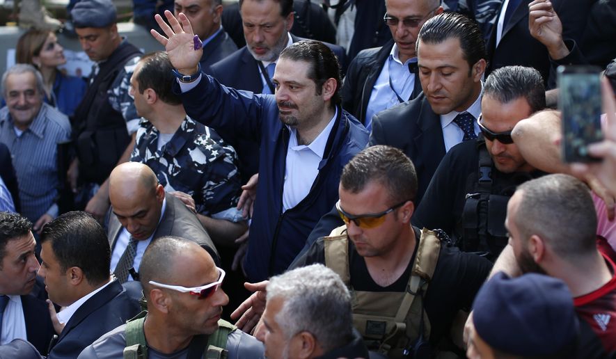 FILE - In this Sunday, May 8, 2016 file photo, Former Lebanese Prime Minister Saad Hariri, center, leader of Lebanon&#39;s parliamentary majority, waves to his supporters after he voted at a polling station during the municipal elections in Beirut, Lebanon. An explosion occurred earlier in June 2020 near the convoy of former Lebanese Prime Minister Saad Hariri when he was on a visit in a mountainous region in Lebanon&#39;s eastern Bekaa Valley, a Saudi-owned TV station reported Sunday, June 28. (AP Photo/Hassan Ammar, File)