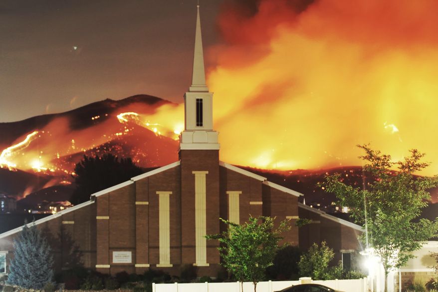 The Traverse Fire burns near homes in Lehi, Utah, Sunday, June 28, 2020. Officials say fireworks caused the wildfire and forced evacuations early Sunday morning. (Justin Reeves via AP)