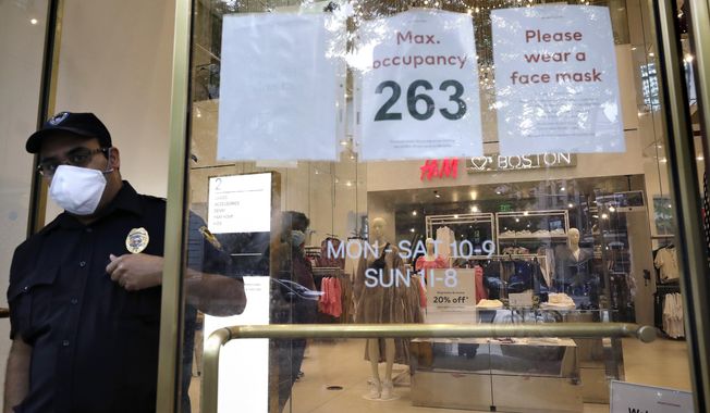 A signs at the entrance to a clothing store requests that customers wear a mask out of concern for the coronavirus, Sunday, June 28, 2020, in Boston. Under step two in phase two of the state&#x27;s plan to reopen the economy during the coronavirus pandemic, beginning June 22, 2020 clothing stores are allowed to offer the use of dressing rooms, by appointment only. (AP Photo/Steven Senne)