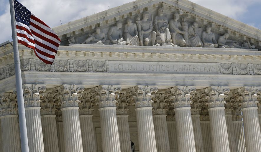 An American flag waves in front of the Supreme Court on Capitol Hill in Washington, Monday, June 29, 2020. (AP Photo/Patrick Semansky)